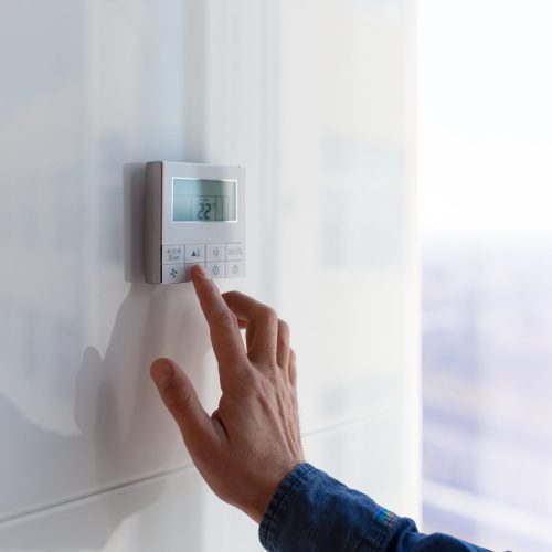 The air conditioning and heating control panel for the apartment and office is located on a white wall