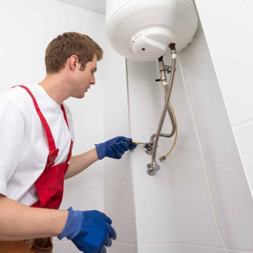 Professional engineer doing a boiler inspection at home.