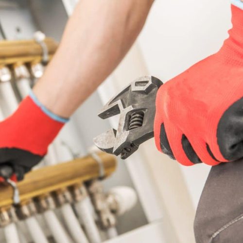 Caucasian Plumber Looking For Issue in the Heating System.